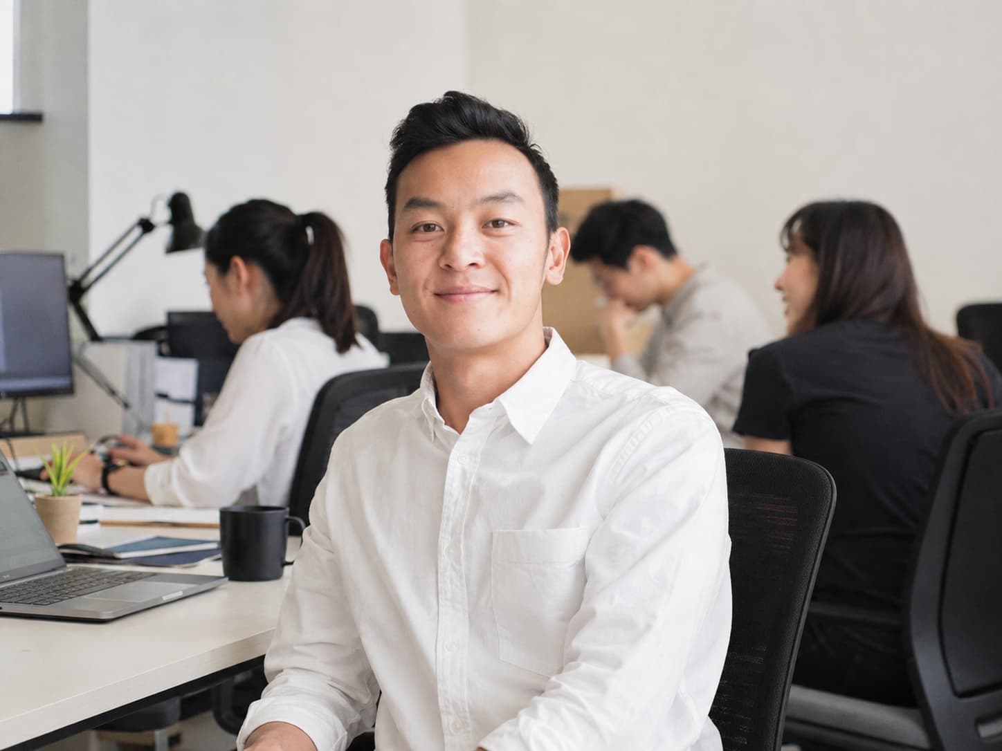 Peter Tu working with the Optimise Digital team in the office